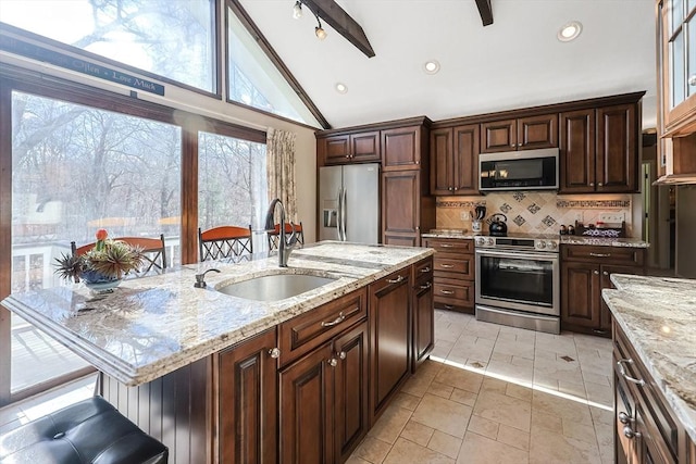 kitchen featuring lofted ceiling with beams, sink, decorative backsplash, light stone countertops, and stainless steel appliances