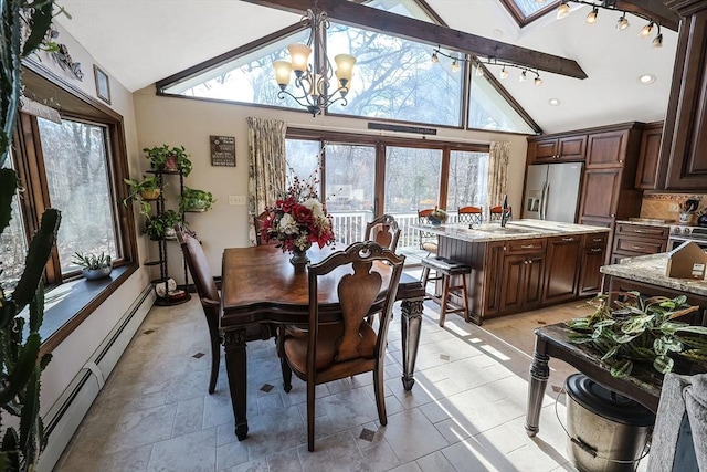 dining room featuring baseboard heating, a skylight, high vaulted ceiling, and a notable chandelier