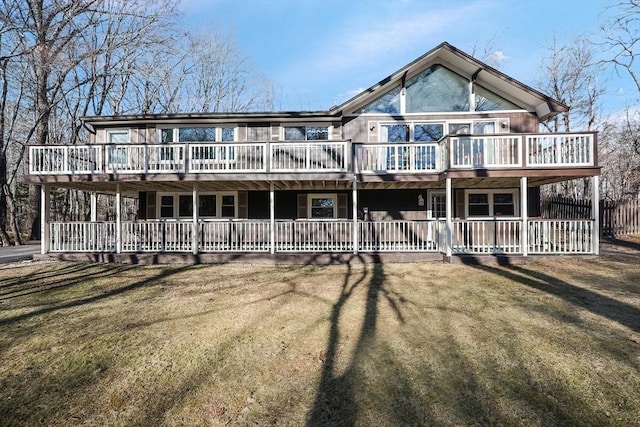 view of front of house featuring a front lawn and a deck