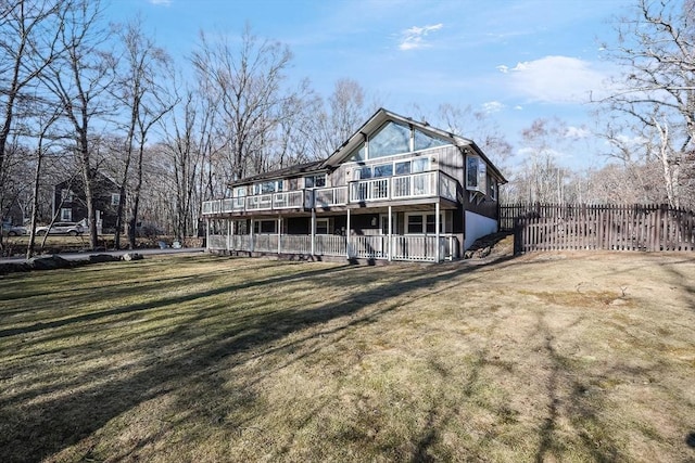 rear view of property featuring a yard and a deck