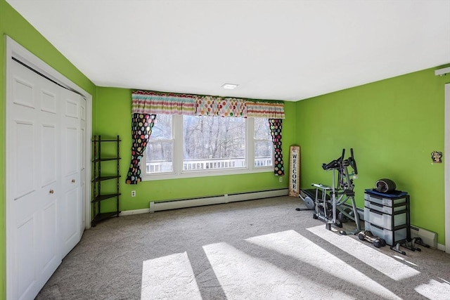 exercise area with light carpet and a baseboard radiator