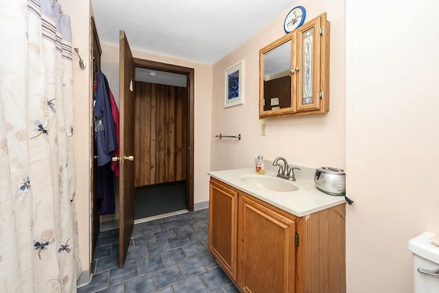 bathroom featuring vanity and toilet