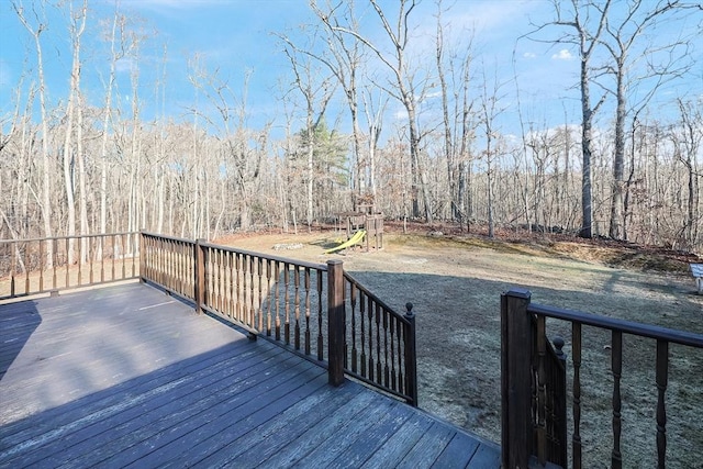 wooden deck featuring a playground