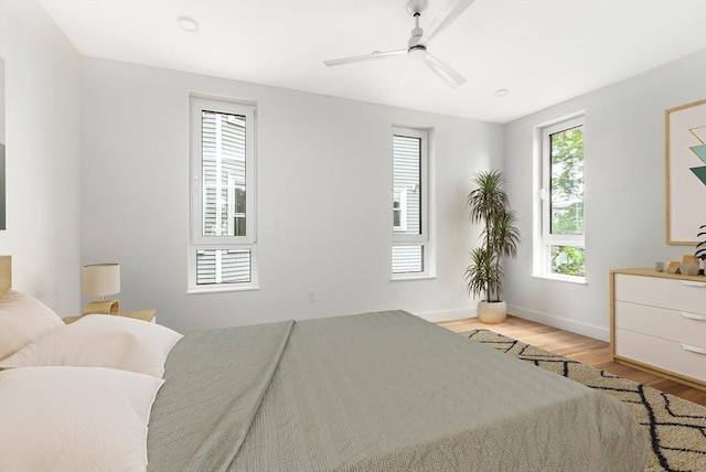 bedroom with ceiling fan and light hardwood / wood-style flooring