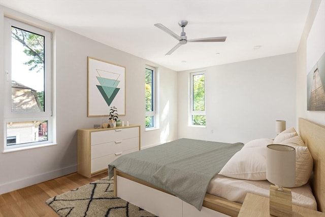 bedroom with ceiling fan and light hardwood / wood-style flooring