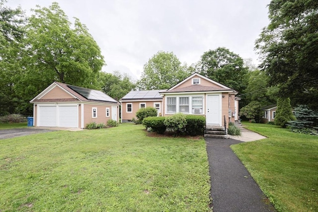 5 Tucker Park, Pepperell, MA 01463 - view of front of home with roof mounted solar panels, a front yard, a garage, and entry steps