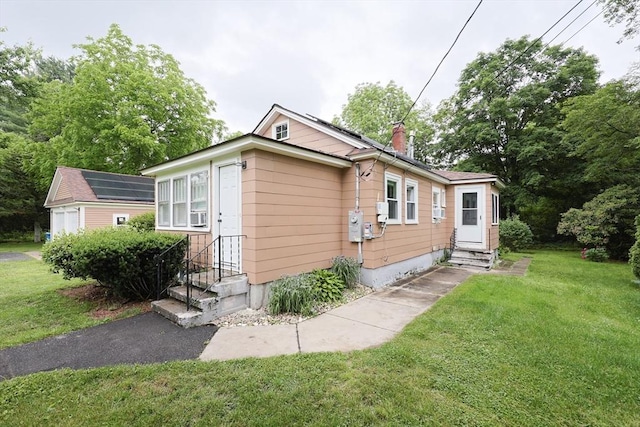 5 Tucker Park, Pepperell, MA 01463 - view of side of property with entry steps, a lawn, and a chimney