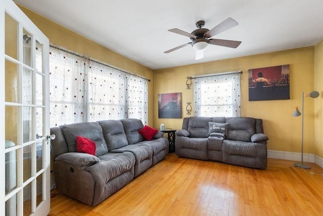 living room with hardwood / wood-style floors, plenty of natural light, and ceiling fan