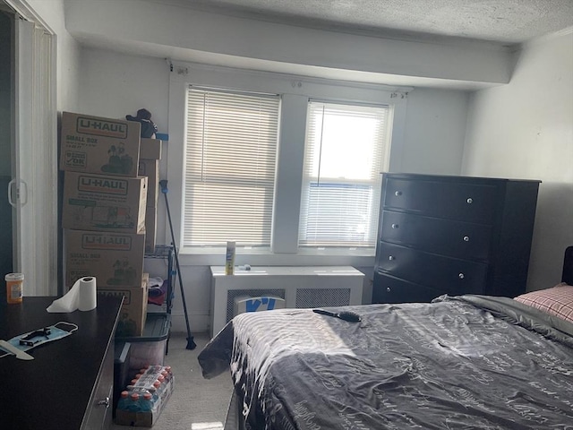 bedroom featuring carpet flooring and a textured ceiling