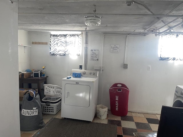 washroom featuring laundry area, washer / dryer, and tile patterned floors