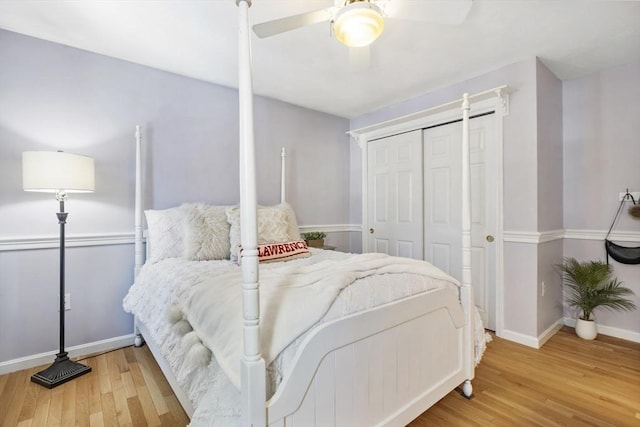 bedroom with ceiling fan, wood-type flooring, and a closet