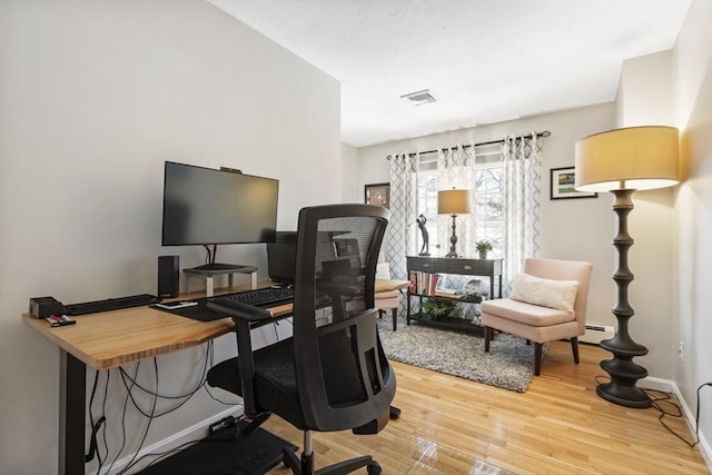 office featuring hardwood / wood-style floors and baseboard heating