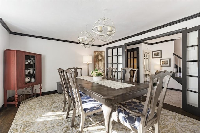 dining area featuring crown molding, dark wood-type flooring, and an inviting chandelier