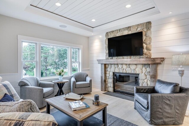 24 Valley Rd, Yarmouth, MA 02673 - living room featuring light wood-style floors, a fireplace, and a raised ceiling