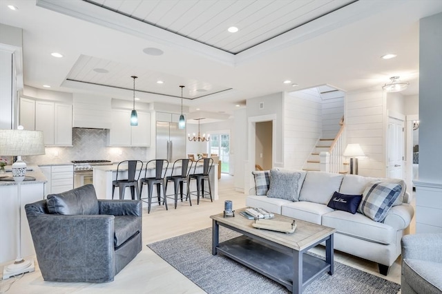 24 Valley Rd, Yarmouth, MA 02673 - living area featuring a tray ceiling, stairway, an inviting chandelier, and recessed lighting