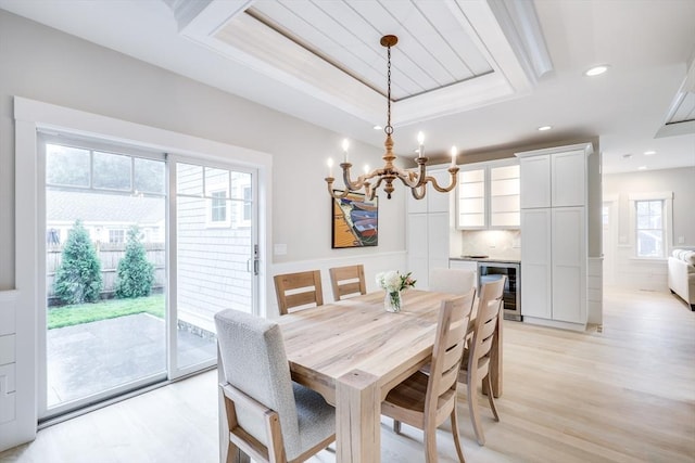 24 Valley Rd, Yarmouth, MA 02673 - dining room with a tray ceiling, recessed lighting, light wood finished floors, and wine cooler