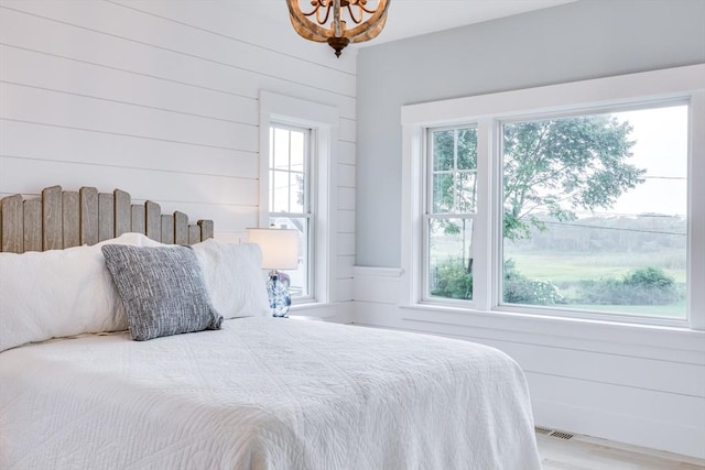 24 Valley Rd, Yarmouth, MA 02673 - bedroom with a chandelier and wood walls