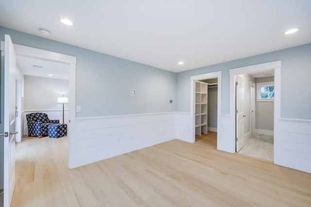 24 Valley Rd, Yarmouth, MA 02673 - unfurnished room featuring light wood-type flooring, a wainscoted wall, and recessed lighting