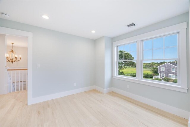 24 Valley Rd, Yarmouth, MA 02673 - empty room featuring visible vents, baseboards, light wood-style flooring, an inviting chandelier, and recessed lighting