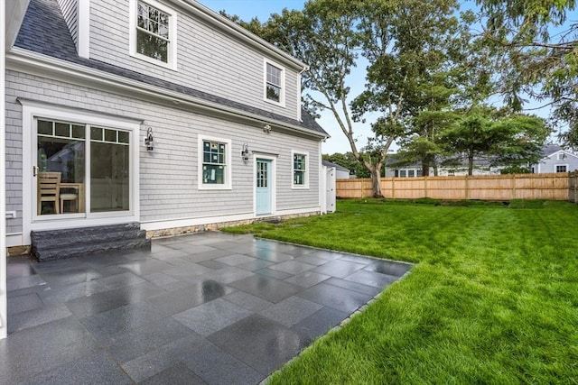 24 Valley Rd, Yarmouth, MA 02673 - back of property featuring entry steps, a lawn, a patio, and fence