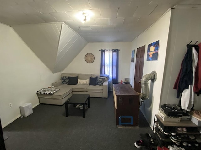 carpeted living area with vaulted ceiling