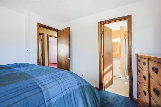 bedroom featuring a sink, ensuite bath, and light carpet