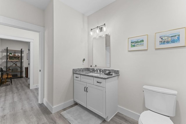 bathroom with vanity, hardwood / wood-style flooring, and toilet