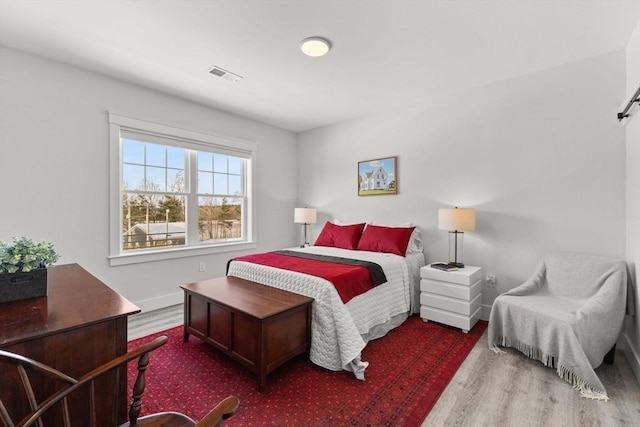 bedroom with dark hardwood / wood-style flooring