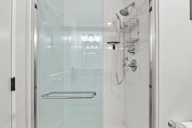 bathroom featuring a shower with shower door