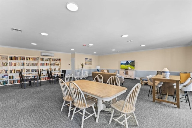 dining room with ornamental molding, carpet flooring, and a wall unit AC