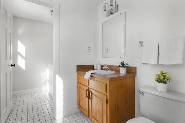 bathroom featuring vanity, toilet, and tile patterned flooring