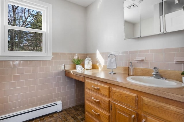 bathroom featuring tile patterned flooring, vanity, tile walls, and baseboard heating