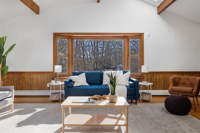 living room with lofted ceiling with beams, baseboard heating, and light hardwood / wood-style floors