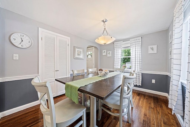 864 Front St, Weymouth, MA 02190 - dining room featuring arched walkways, dark wood-type flooring, and baseboards