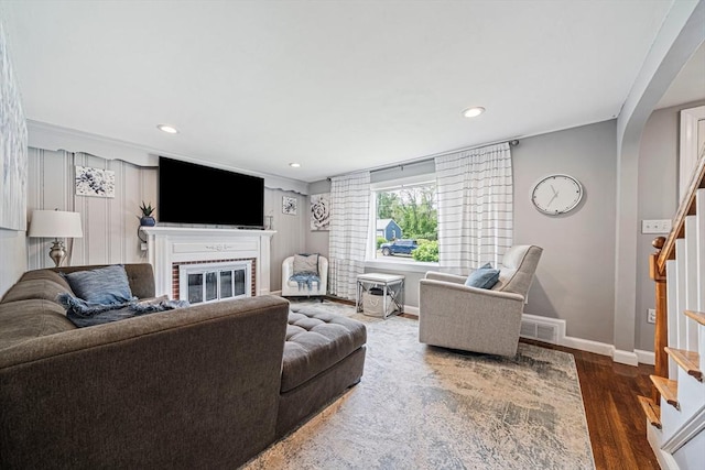864 Front St, Weymouth, MA 02190 - living room with stairs, a fireplace, wood finished floors, baseboards, and arched walkways