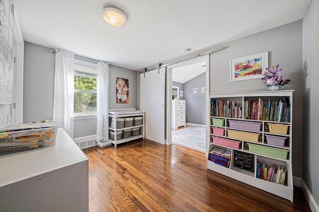 864 Front St, Weymouth, MA 02190 - bedroom featuring wood finished floors, baseboards, and a barn door