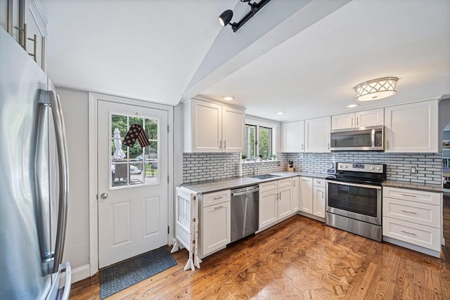 864 Front St, Weymouth, MA 02190 - kitchen featuring stainless steel appliances, a sink, backsplash, white cabinetry, and light stone countertops