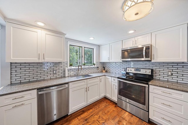 864 Front St, Weymouth, MA 02190 - kitchen featuring stainless steel appliances, a sink, white cabinetry, backsplash, and recessed lighting