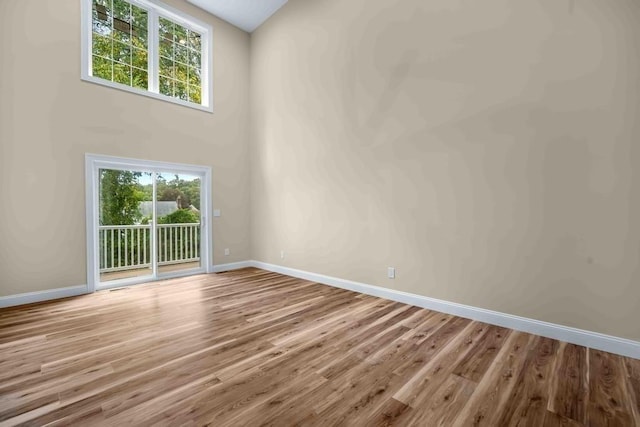 empty room featuring baseboards and wood finished floors
