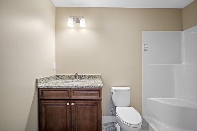 full bath featuring toilet, vanity, baseboards, and walk in shower