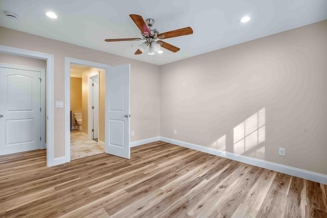 unfurnished bedroom with recessed lighting, light wood-style flooring, and baseboards