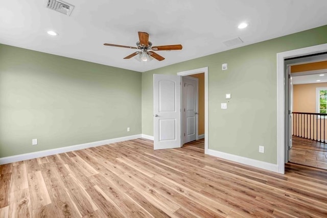 empty room featuring ceiling fan, light wood-style flooring, visible vents, recessed lighting, and baseboards