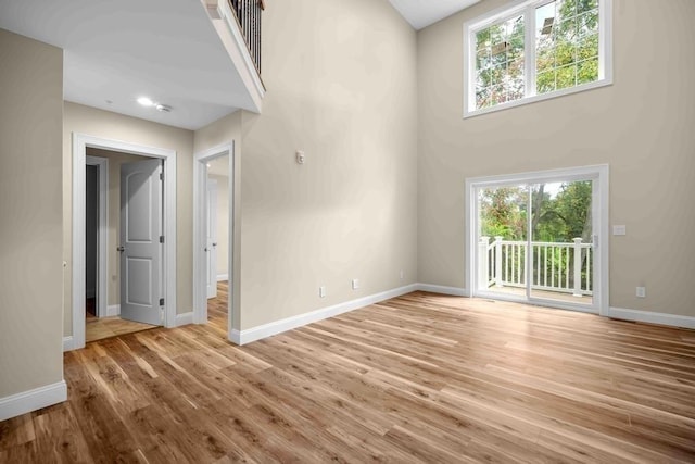 unfurnished living room featuring baseboards and plenty of natural light
