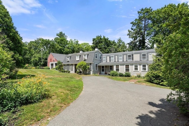 163/165 Highland St, Dedham, MA 02026 - view of front facade with a chimney and a front lawn