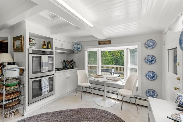 163/165 Highland St, Dedham, MA 02026 - kitchen featuring stainless steel double oven, under cabinet range hood, white cabinetry, a baseboard heating unit, and beam ceiling