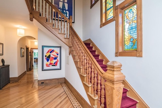75 Lyman Rd, Northampton, MA 01060 - stairs featuring arched walkways, wood finished floors, and baseboards