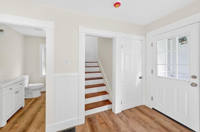 51 Ryder St, Dartmouth, MA 02747 - entryway featuring light wood finished floors, stairway, and a wainscoted wall