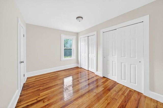 51 Ryder St, Dartmouth, MA 02747 - unfurnished bedroom with multiple closets and light wood-type flooring