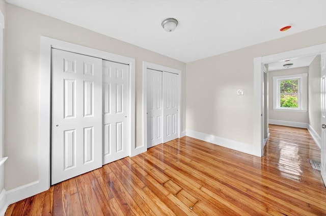 51 Ryder St, Dartmouth, MA 02747 - unfurnished bedroom with two closets and light wood-style flooring