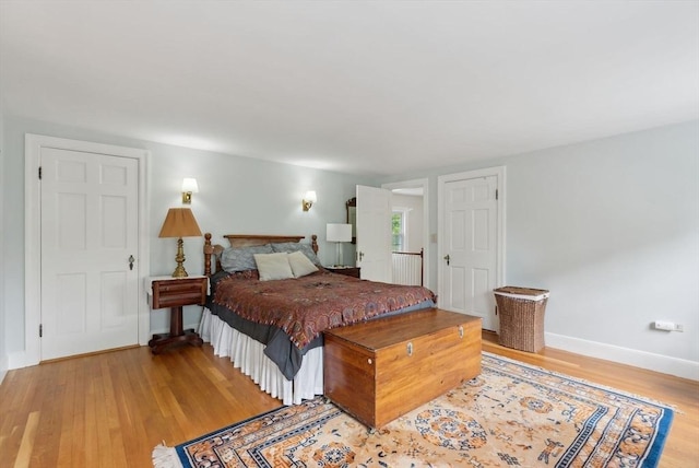 bedroom featuring light wood-type flooring and baseboards